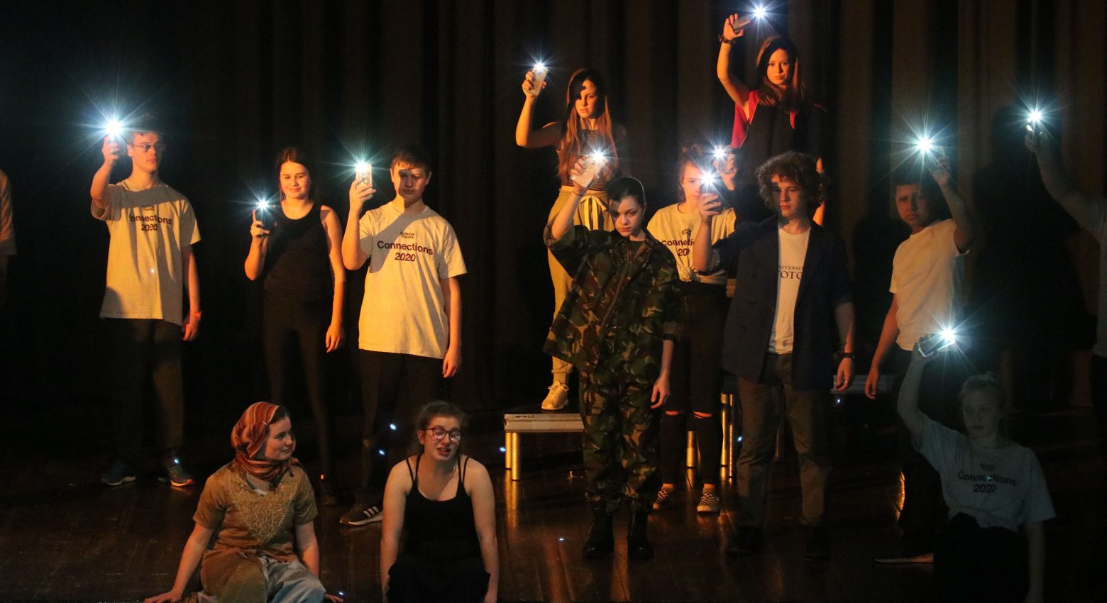 Students holding up lights