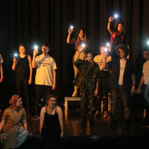 Students holding up lights