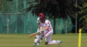 Student playing cricket